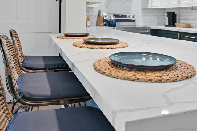 a view of a kitchen with kitchen island stainless steel appliances a sink and a stove