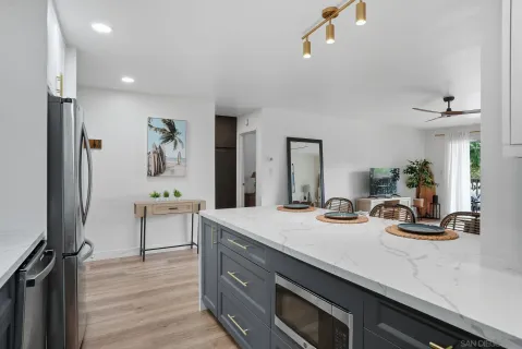 a view of living room with granite countertop furniture and wooden floor