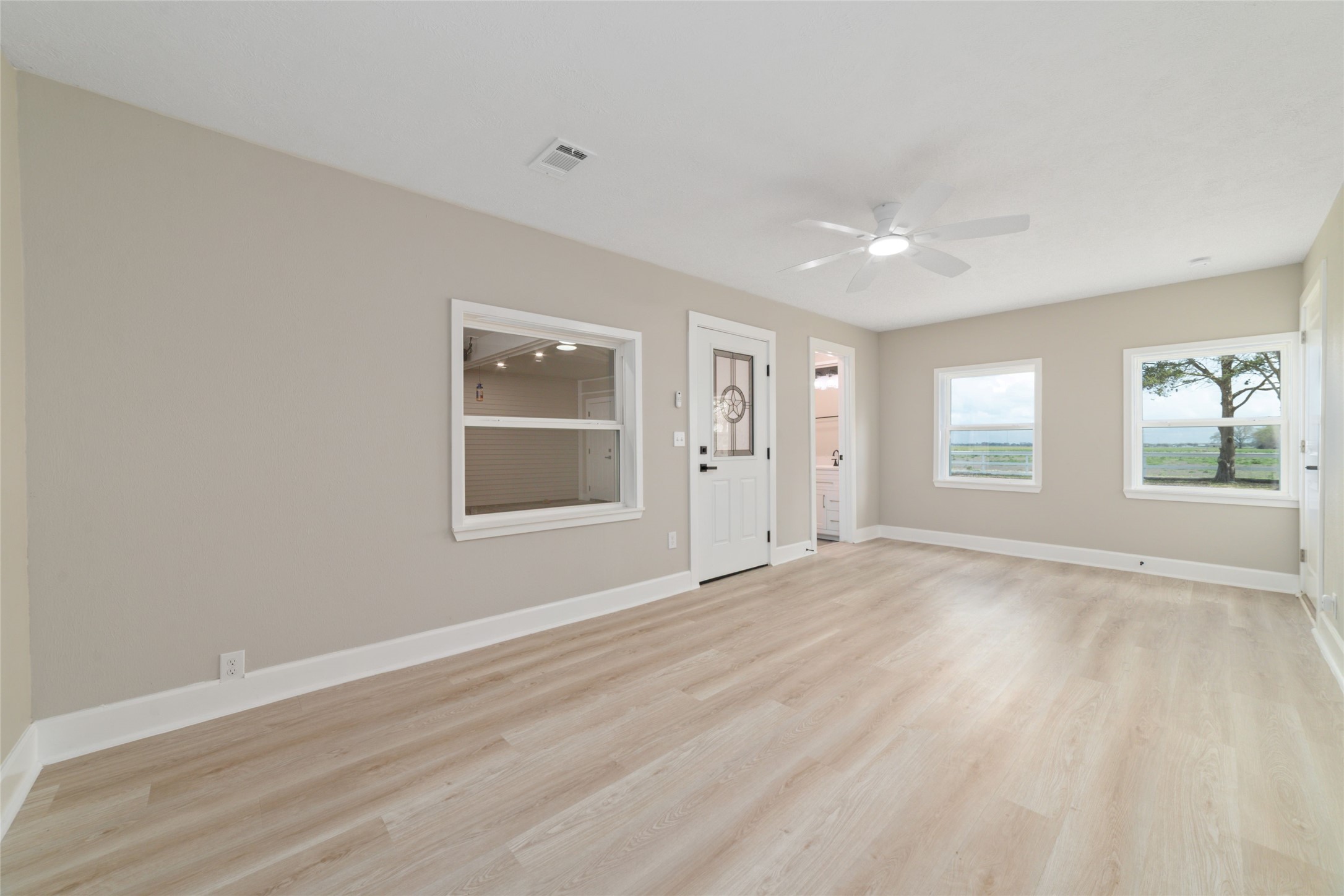 13431 Vrlla Road Guy, TX 77444 - Photo 11 of 32 a view of an empty room with wooden floor and a window