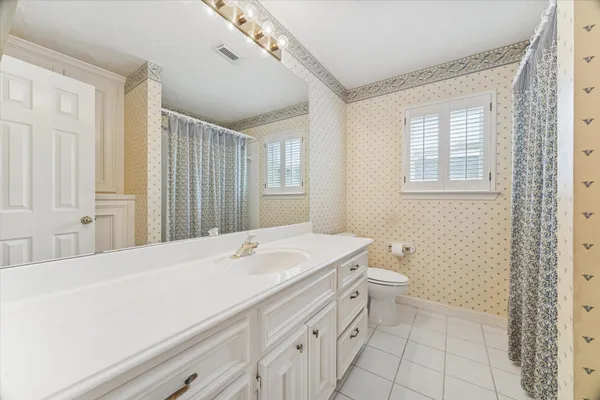 a bathroom with a sink a vanity and a mirror