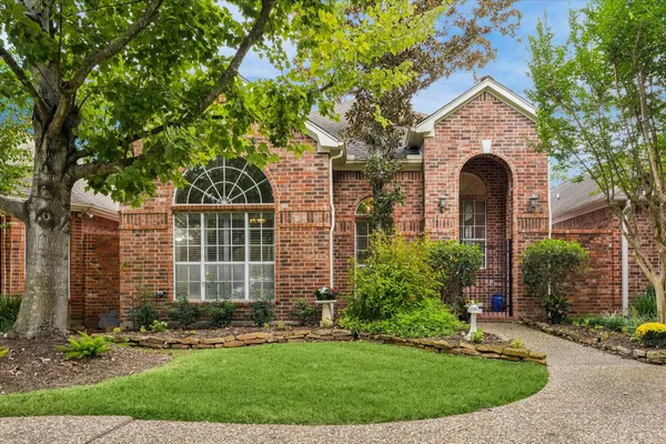 front view of a house with a garden