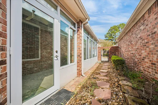 a view of a brick house with a large window