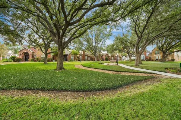 a huge green field with lots of trees