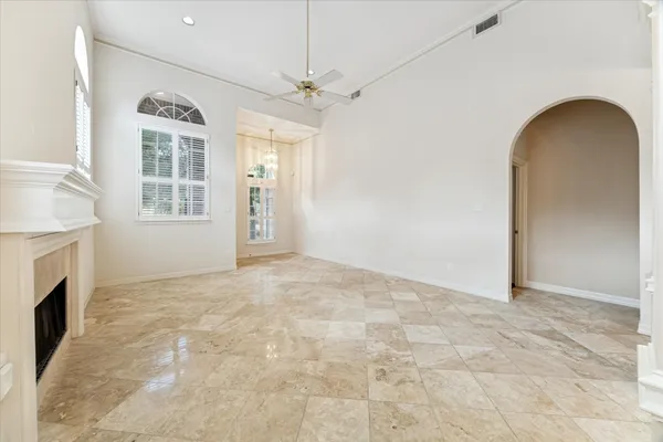 a view of empty room with fireplace and wooden floor