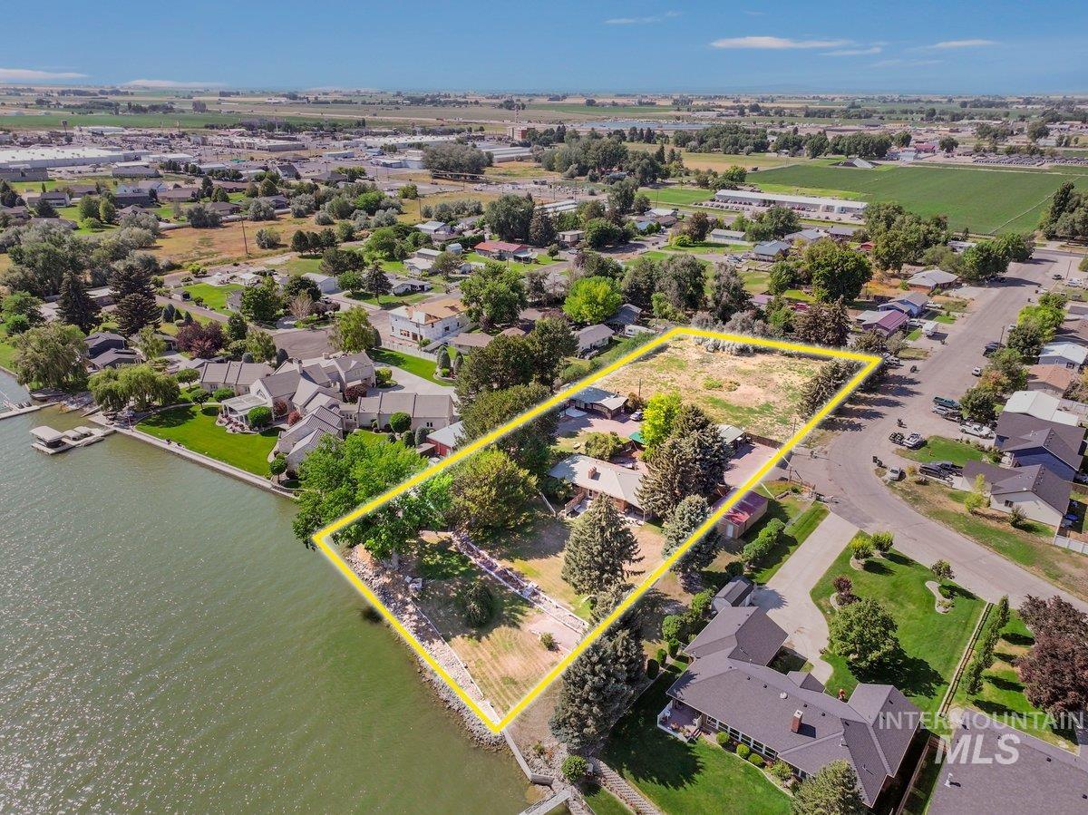 1801 Y Street Heyburn, ID 83336 - Photo 2 of 42 Aerial perspective of suburban area with property boundaries highlighted and a large body of water