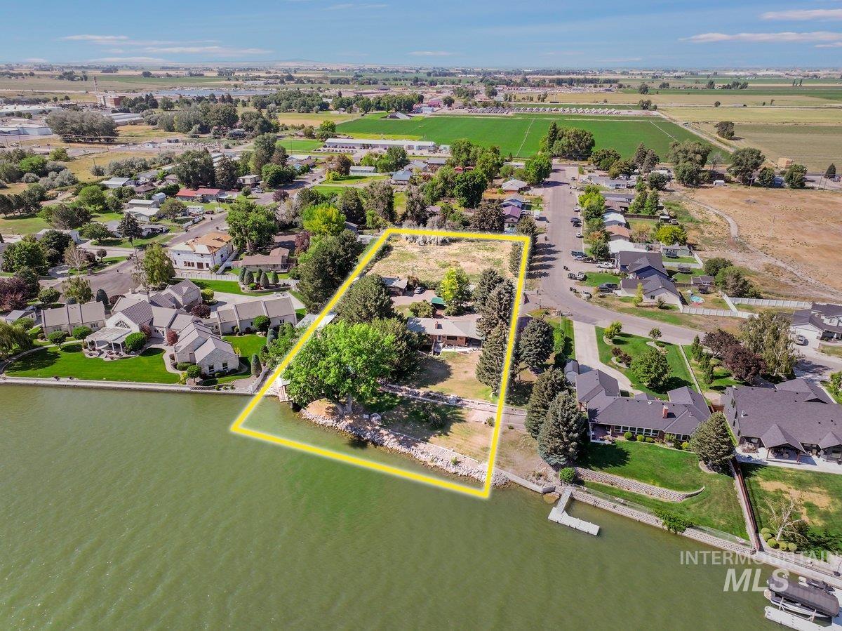 1801 Y Street Heyburn, ID 83336 - Photo 3 of 42 Aerial view of residential area with property parcel outlined and a large body of water