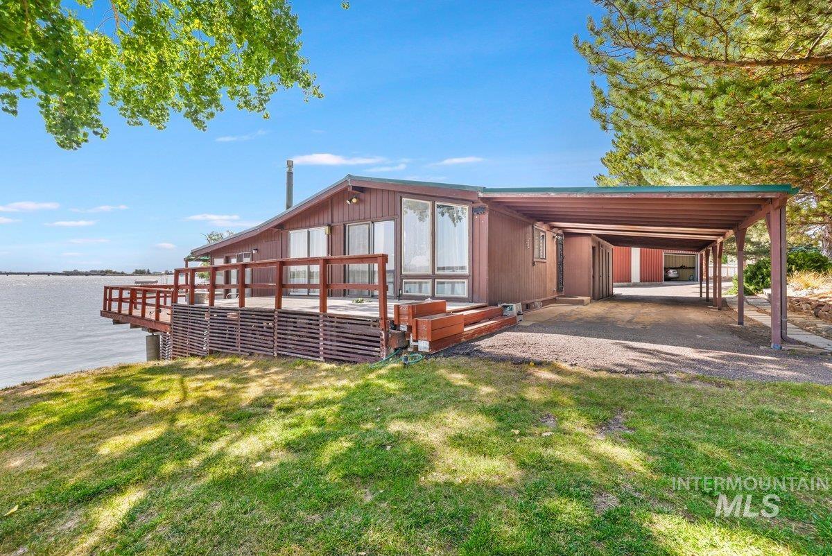 1801 Y Street Heyburn, ID 83336 - Photo 35 of 42 Exterior space with a lawn, a deck with water view, and a carport