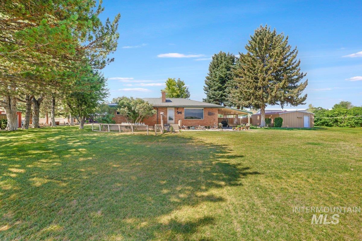 1801 Y Street Heyburn, ID 83336 - Photo 37 of 42 View of green lawn featuring a patio and an outbuilding