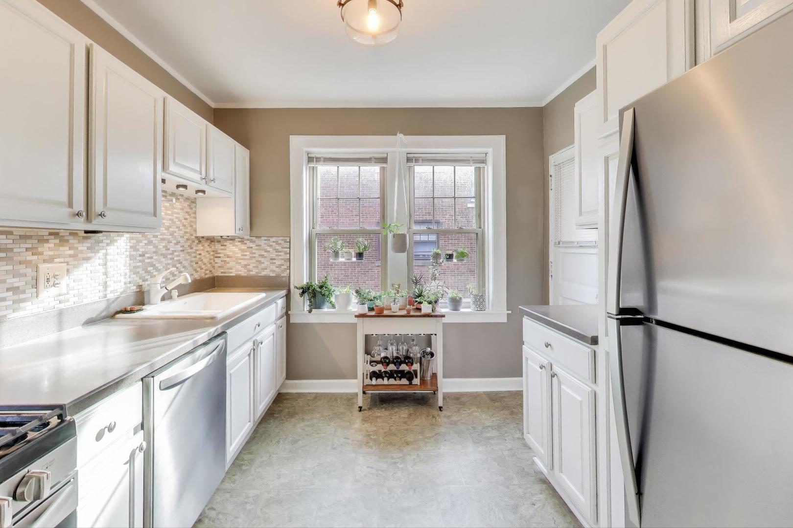 108 Lincoln Avenue, Unit 2B Riverside, IL 60546 - Photo 8 of 18 a kitchen with a sink and a refrigerator