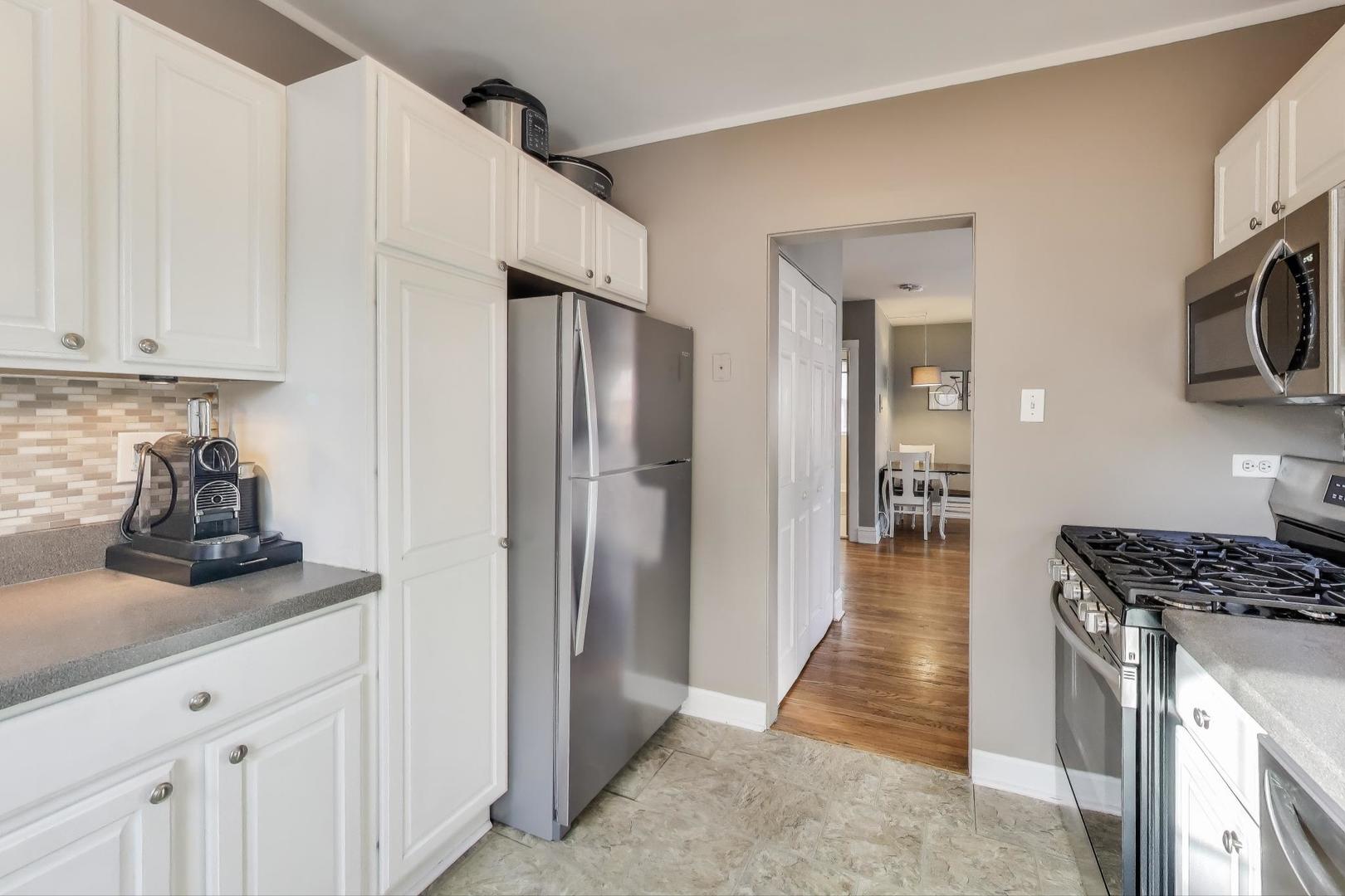 108 Lincoln Avenue, Unit 2B Riverside, IL 60546 - Photo 9 of 18 a kitchen with stainless steel appliances a refrigerator a stove and white cabinets