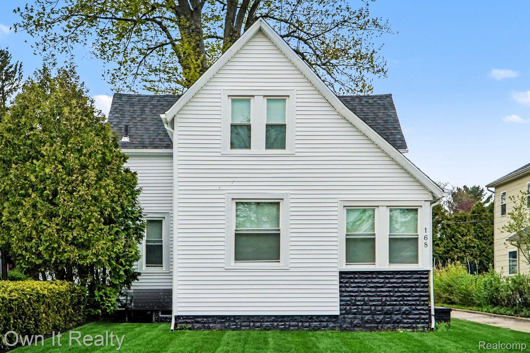 168 Kerby Road Grosse Pointe, MI 48236 - Photo 1 of 36 Front of house featuring roof with shingles and a yard