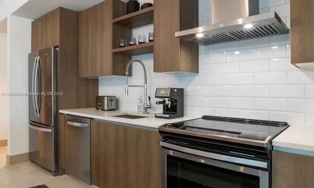 a kitchen with a stove and a refrigerator