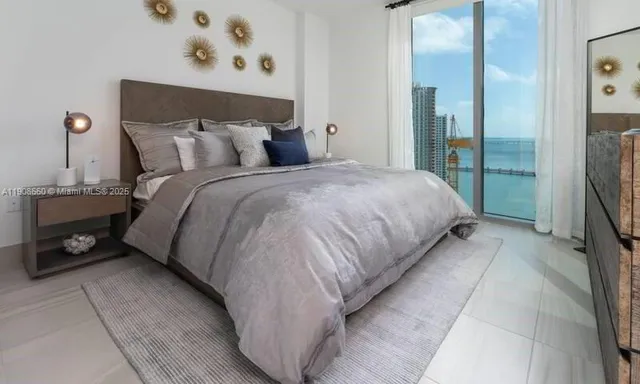 a bed sitting in a bedroom next to a window