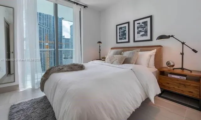 a bedroom with a bed and a night stand