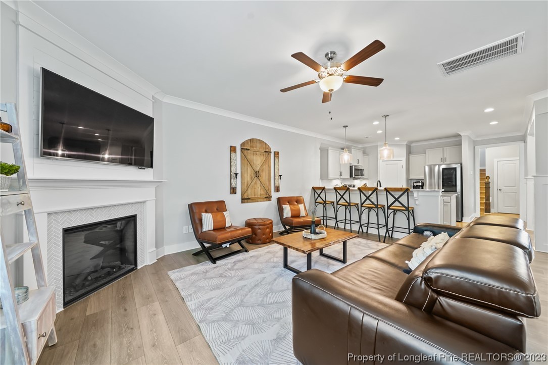 68 Spruce Hollow Circle Spring Lake, NC 28390 - Photo 12 of 48 a living room with furniture a flat screen tv and a fireplace