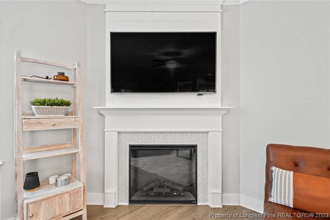 68 Spruce Hollow Circle Spring Lake, NC 28390 - Photo 15 of 48 a living room with a fireplace and a wooden floor