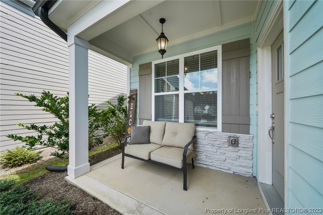 68 Spruce Hollow Circle Spring Lake, NC 28390 - Photo 2 of 48 a balcony with furniture and a potted plant