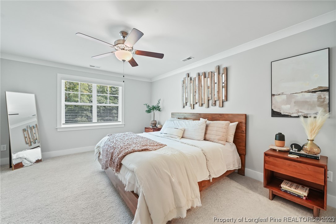 68 Spruce Hollow Circle Spring Lake, NC 28390 - Photo 25 of 48 a bedroom with a bed and a window