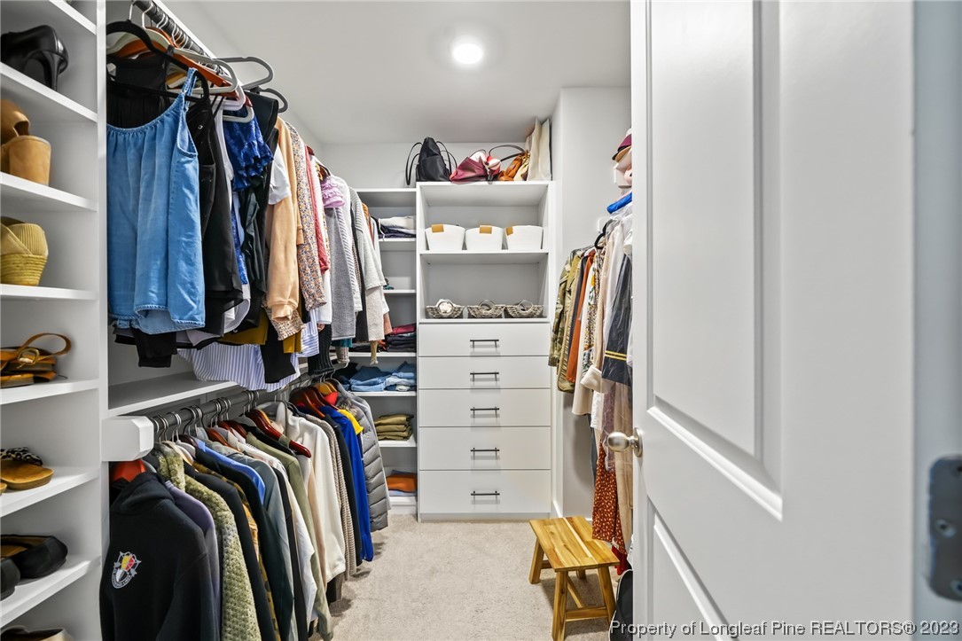 68 Spruce Hollow Circle Spring Lake, NC 28390 - Photo 26 of 48 a view of walk in closet with clothes and shoes