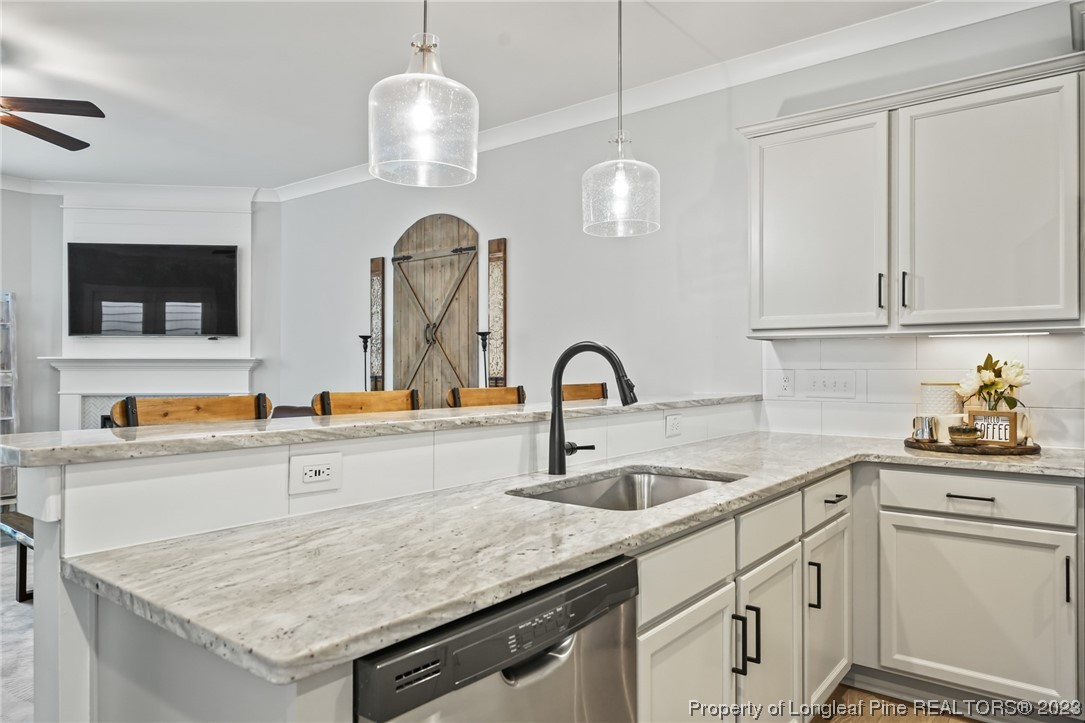 68 Spruce Hollow Circle Spring Lake, NC 28390 - Photo 10 of 48 a kitchen with stainless steel appliances granite countertop a sink a stove and a wooden floors