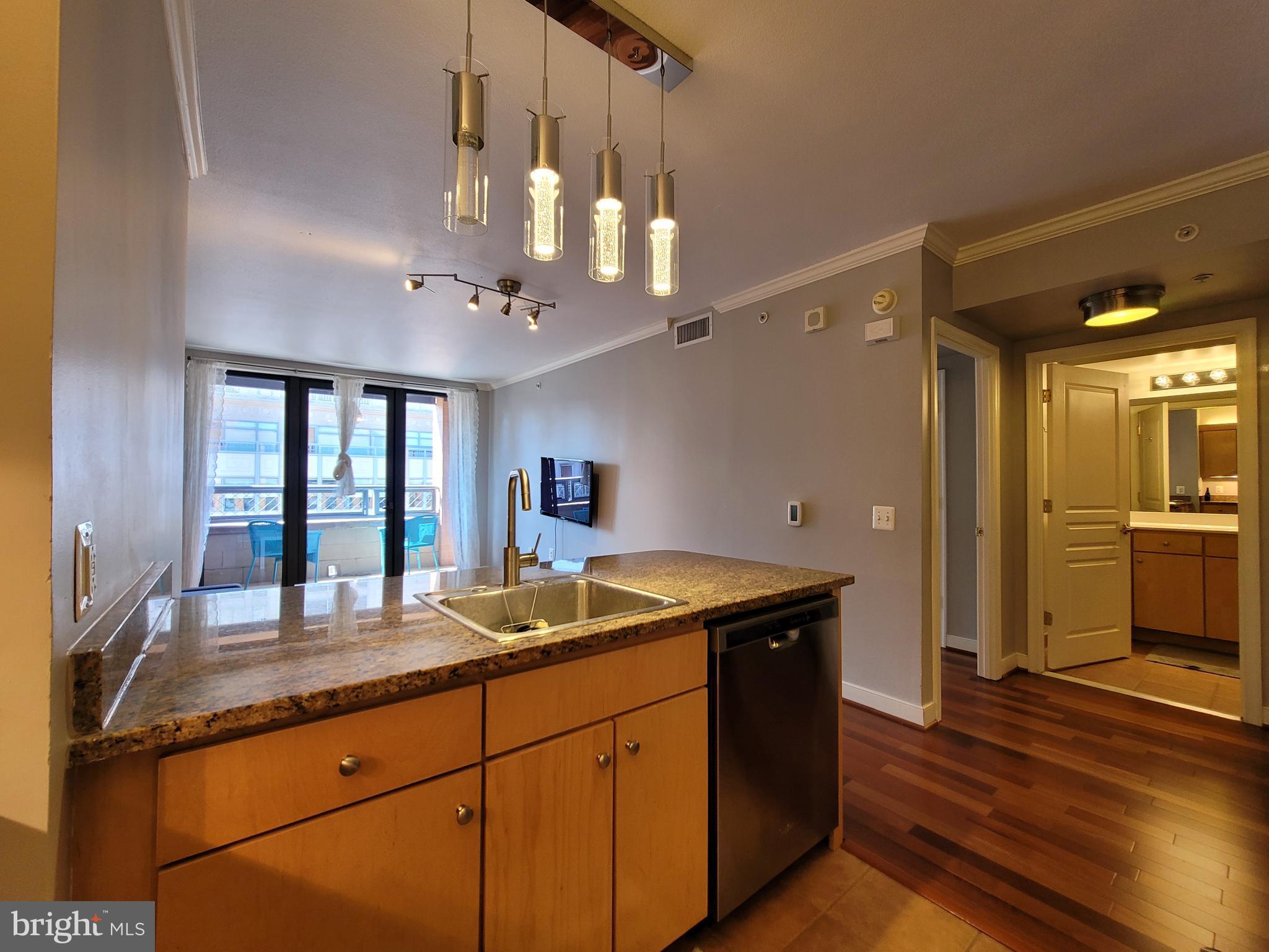 631 D Street Northwest, Unit 1132 Washington, DC 20004 - Photo 11 of 58 a kitchen with granite countertop a sink counter top space and cabinets