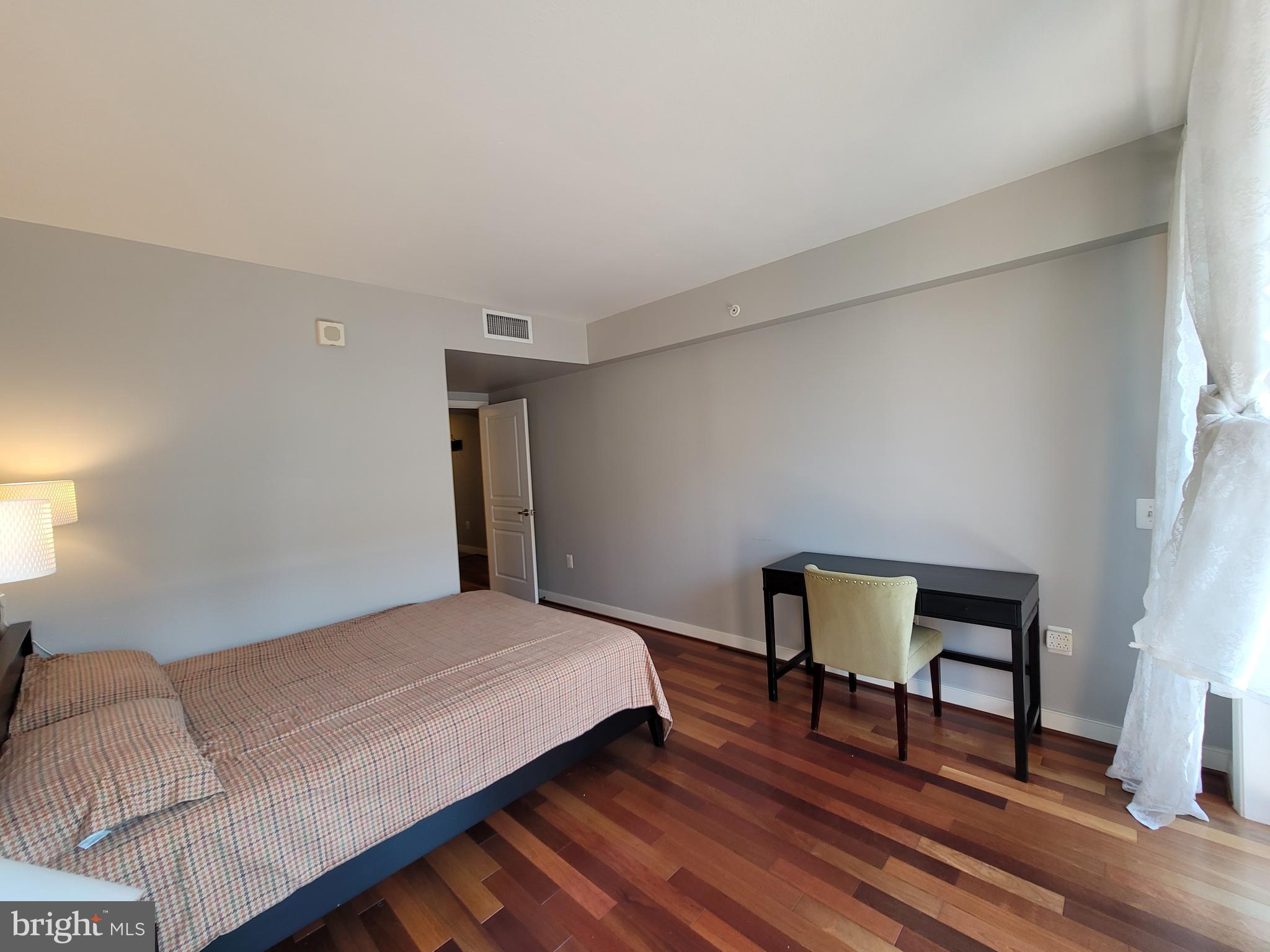 631 D Street Northwest, Unit 1132 Washington, DC 20004 - Photo 22 of 58 a bedroom with a bed and a mirror