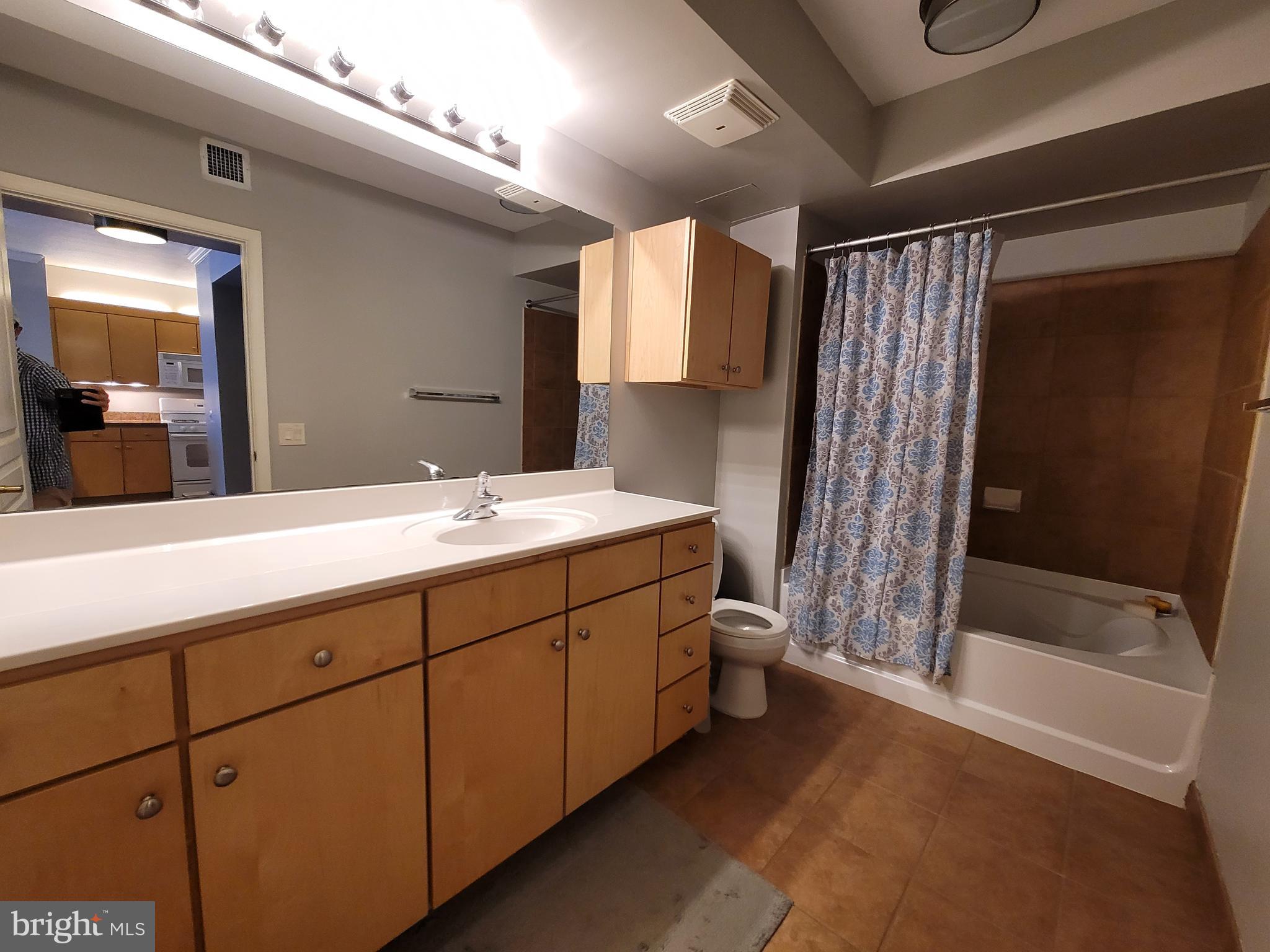 631 D Street Northwest, Unit 1132 Washington, DC 20004 - Photo 24 of 58 a bathroom with a double vanity sink toilet and shower