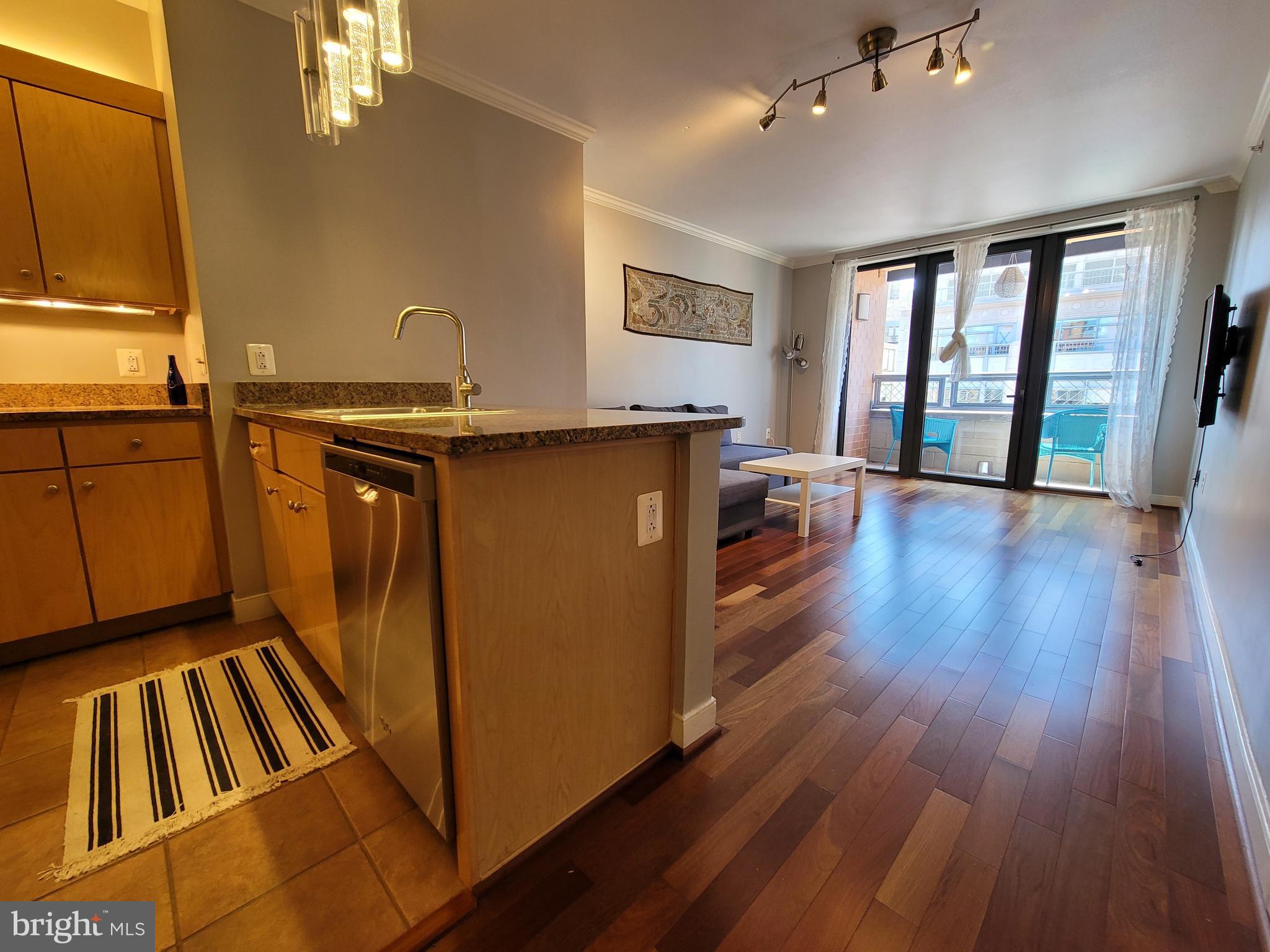 631 D Street Northwest, Unit 1132 Washington, DC 20004 - Photo 7 of 58 a view of a kitchen with wooden floor and furniture
