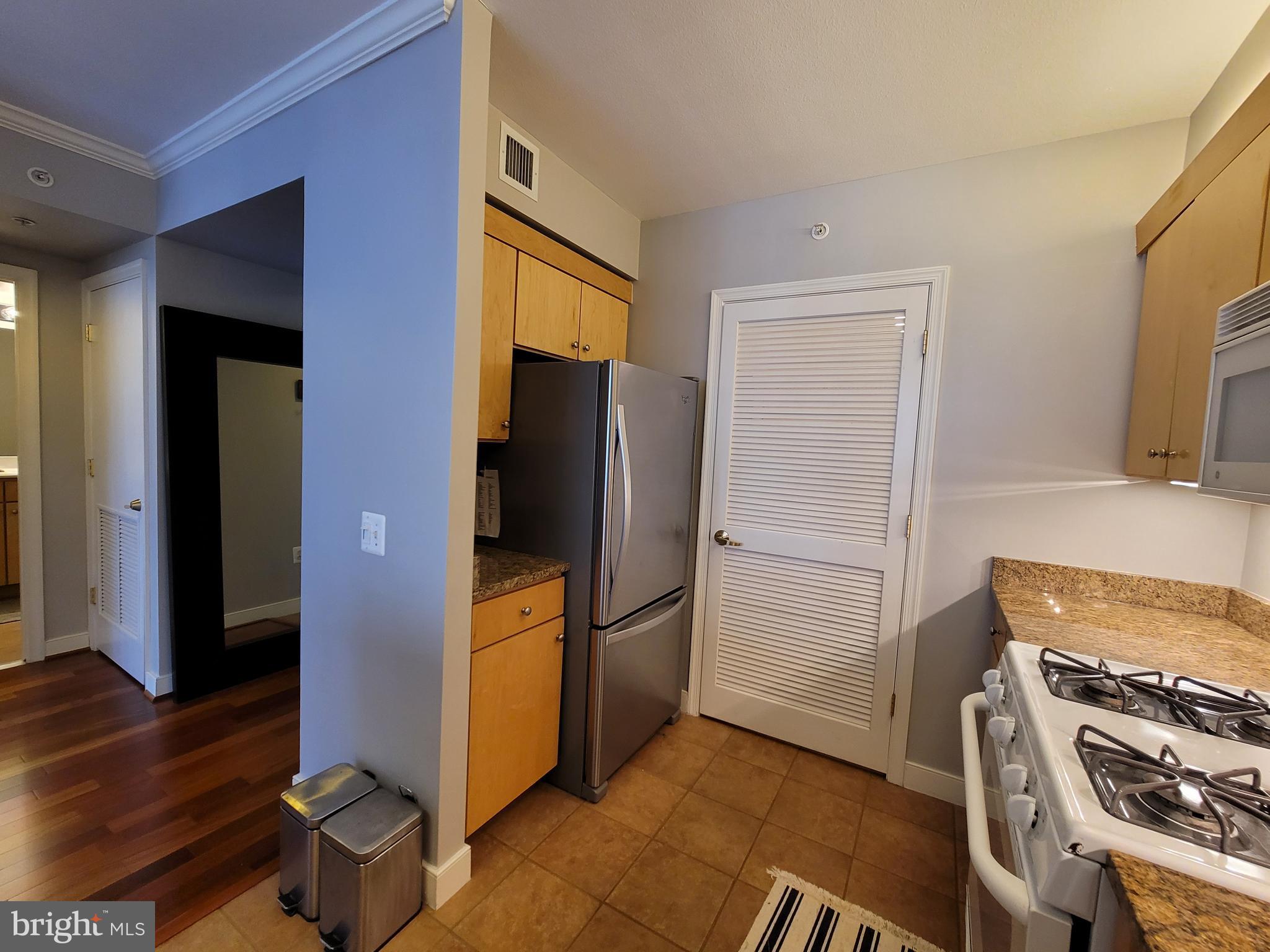631 D Street Northwest, Unit 1132 Washington, DC 20004 - Photo 8 of 58 a kitchen with a refrigerator and a stove top oven
