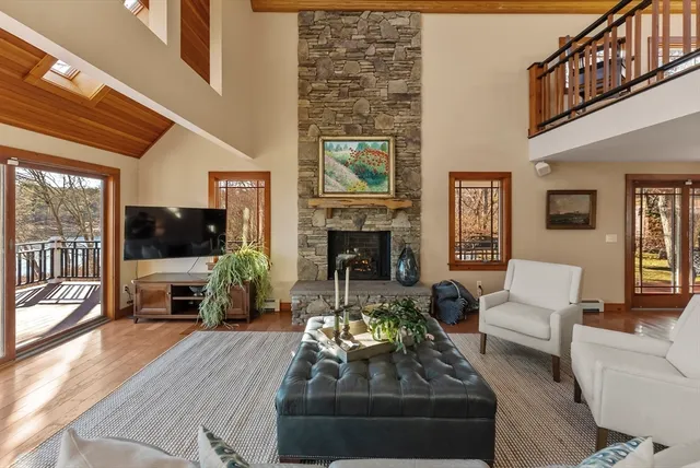 a living room with furniture a flat screen tv and a fireplace