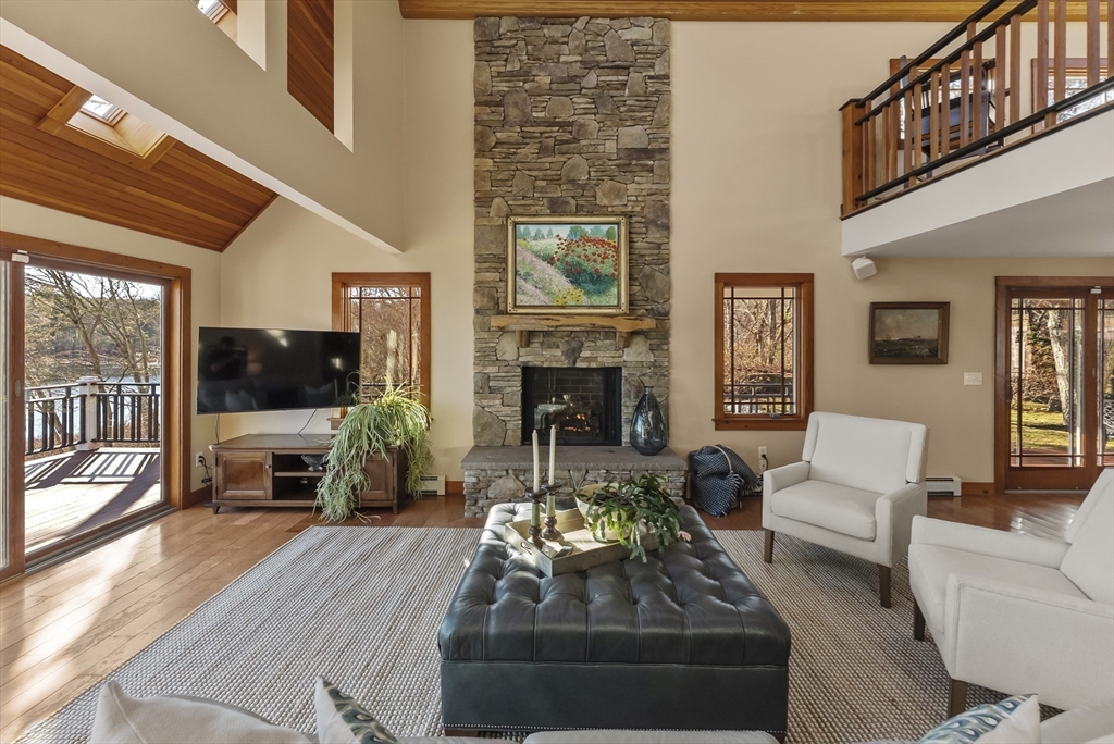 82 Lake Road Plymouth, MA 02360 - Photo 12 of 42 a living room with furniture a flat screen tv and a fireplace