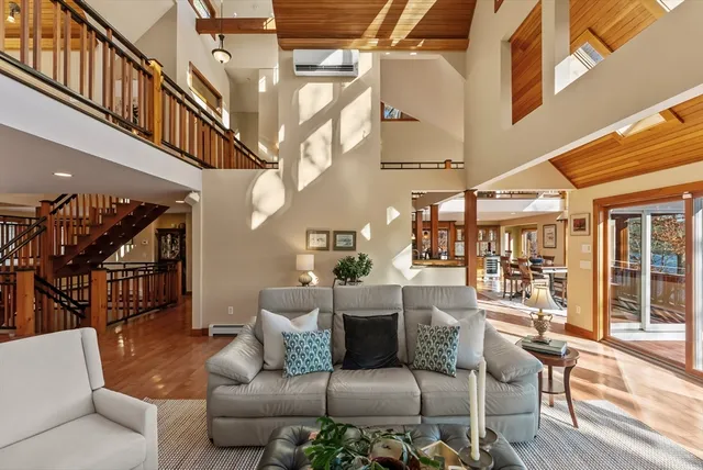 a view of a livingroom with furniture and floor to ceiling windows
