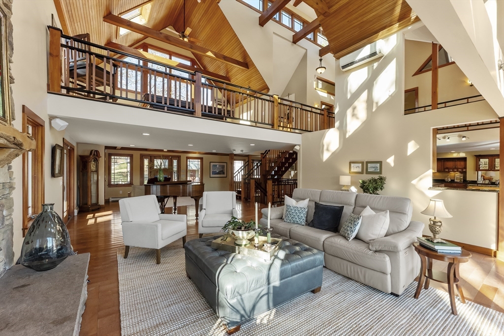 82 Lake Road Plymouth, MA 02360 - Photo 15 of 42 a view of a patio with couches and potted plants with wooden floor