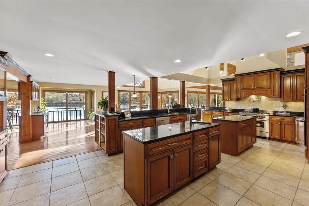 82 Lake Road Plymouth, MA 02360 - Photo 16 of 42 a large kitchen with kitchen island granite countertop a large counter top and stainless steel appliances