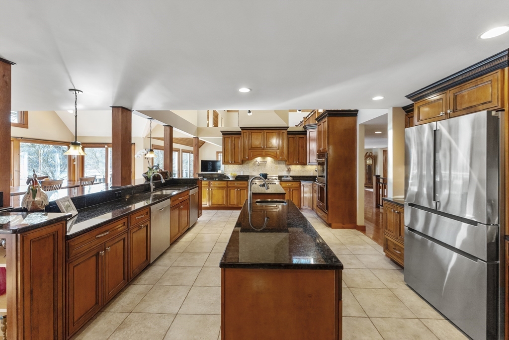 82 Lake Road Plymouth, MA 02360 - Photo 17 of 42 a large kitchen with kitchen island a large counter top space a sink a stove and a refrigerator