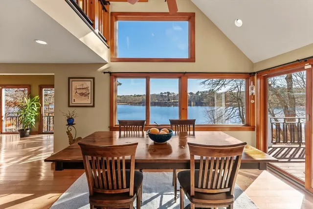 a dining room with furniture a chandelier and wooden floor