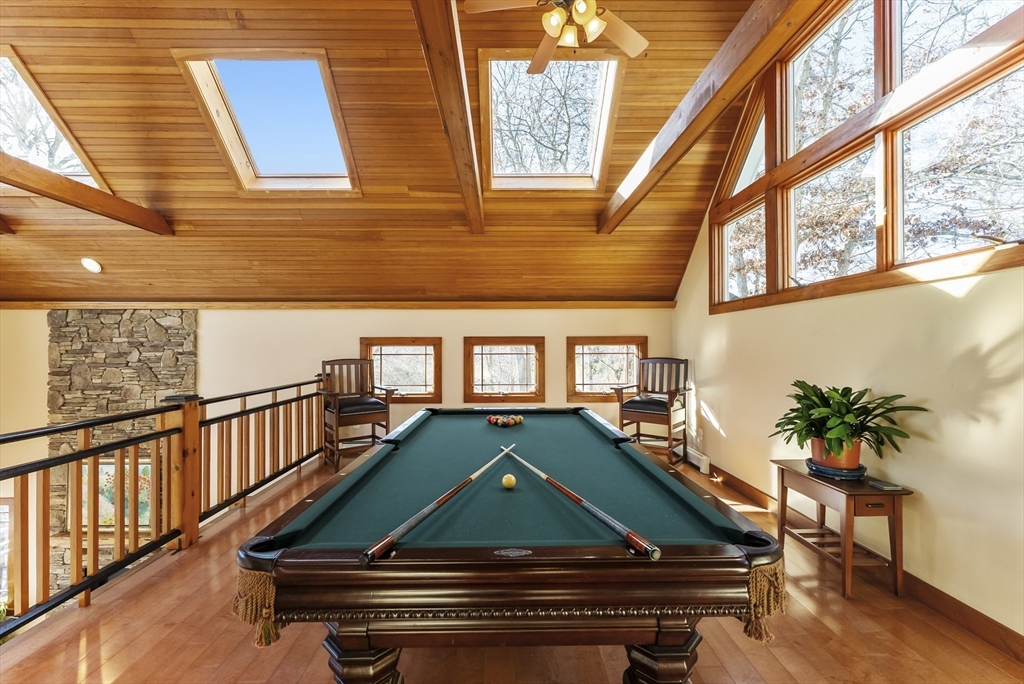82 Lake Road Plymouth, MA 02360 - Photo 26 of 42 a room with wooden floor pool table and chairs