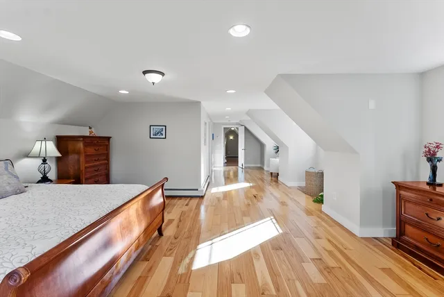 a bed room with a bed and a view of kitchen