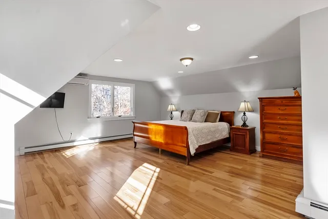 a spacious bedroom with a bed and window