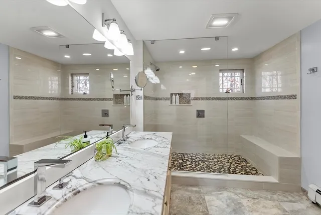 a bathroom with a sink a toilet and shower