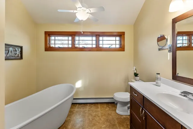 a bathroom with a sink a toilet and a mirror