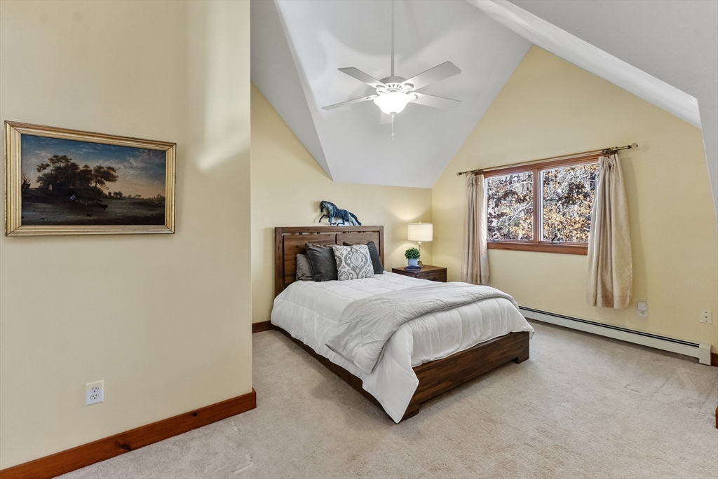 82 Lake Road Plymouth, MA 02360 - Photo 32 of 42 a spacious bedroom with a bed and a painting on the wall