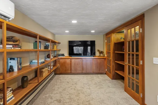 a large kitchen with stainless steel appliances a large counter top and a wooden floors