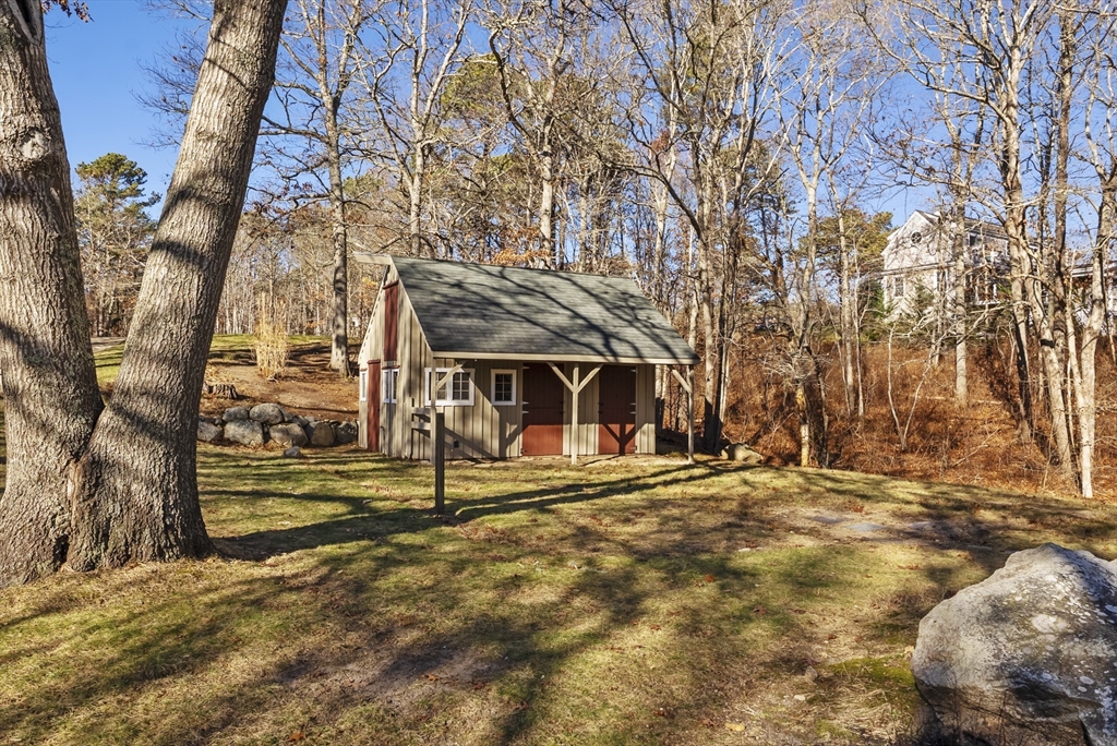 82 Lake Road Plymouth, MA 02360 - Photo 42 of 42 a view of a house with trees in the background
