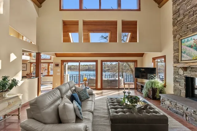 a living room with furniture fireplace and a floor to ceiling window