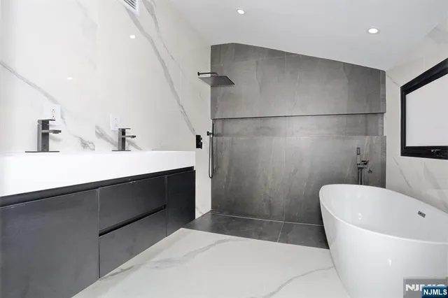 a bathroom with a bathtub and a sink