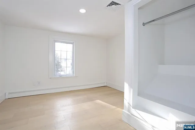 an empty room with a empty space and windows