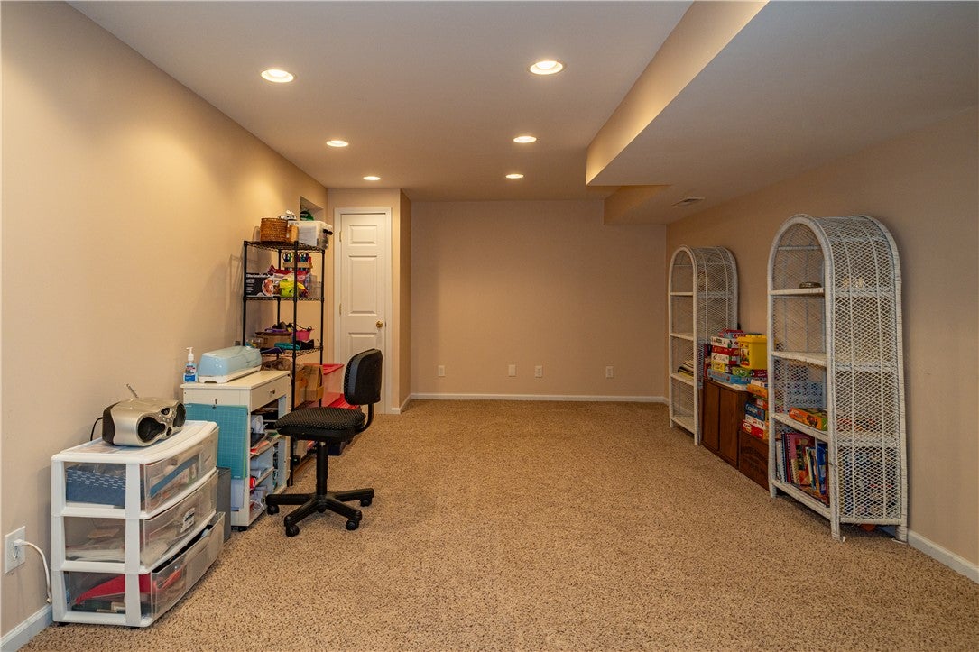 10765 Stone Ridge Way Harrison, OH 45030 - Photo 43 of 68 Recessed lighting illuminates this versatile recreation room, offering a neutral palette for personalized decor.