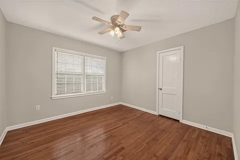 a bedroom with a bed and a lamp on the dresser