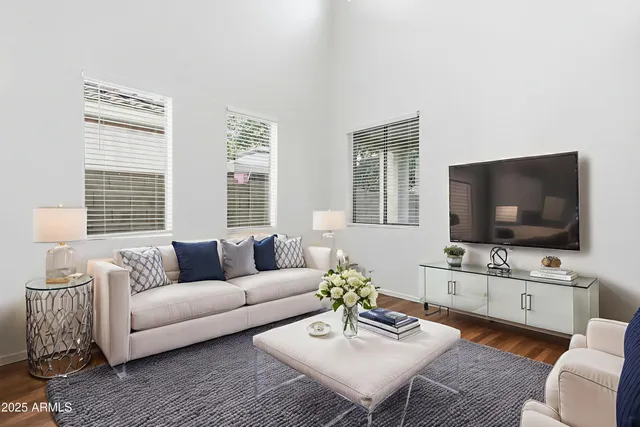 a bedroom with a bed and a painting on the wall